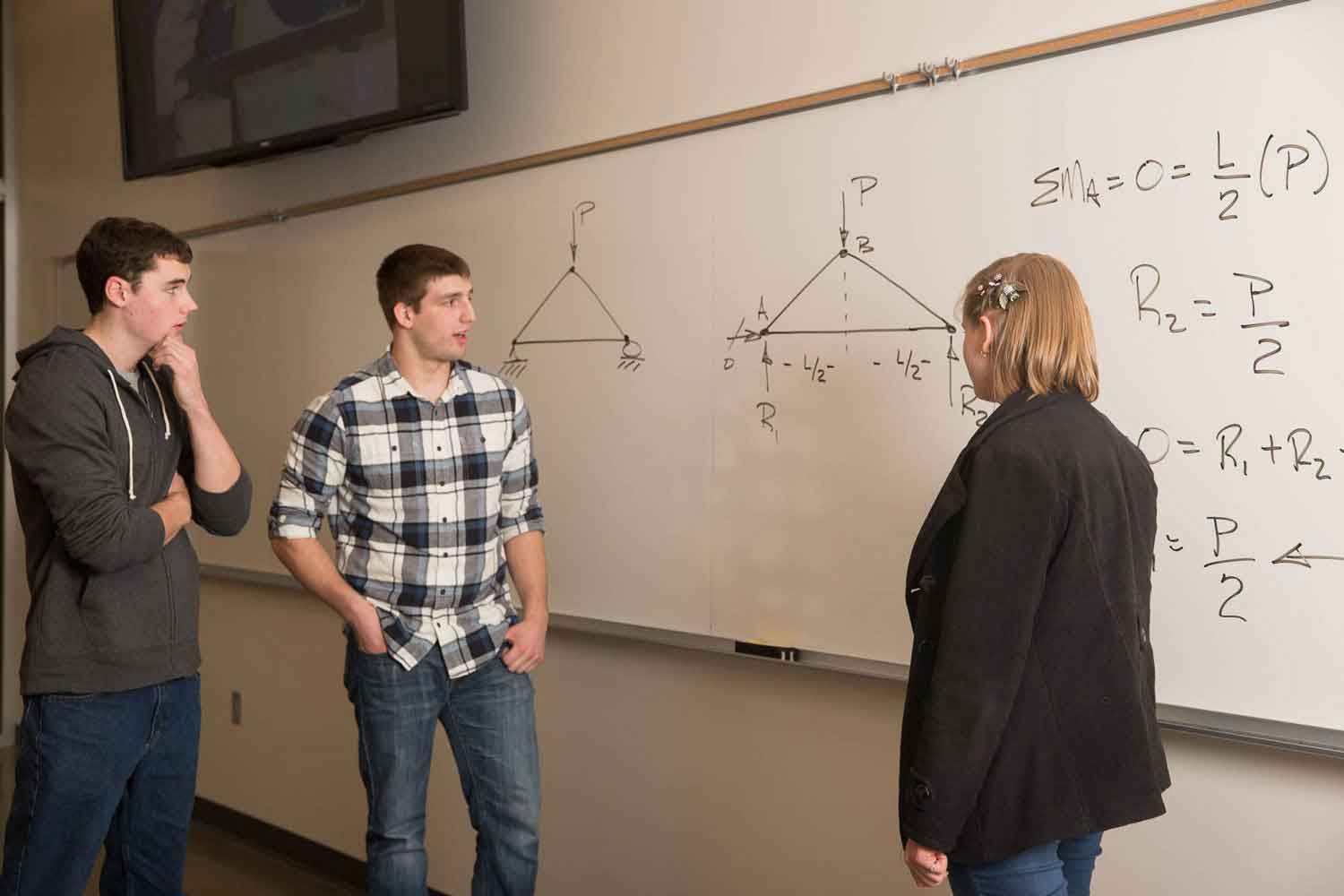 Students examining an equation.